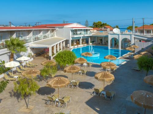 an overhead view of a resort with a pool and umbrellas at Hotel Papillon in Argassi