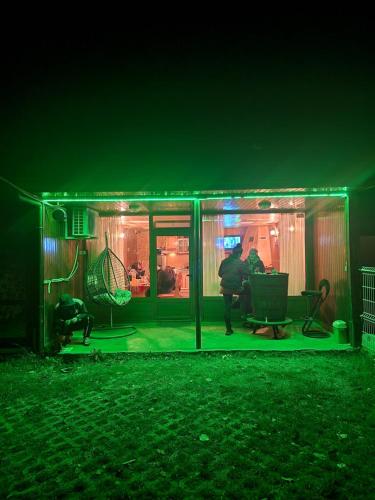 a man standing inside of a house at night at Rebeka Guest House in Tryavna