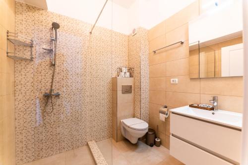 a bathroom with a shower and a toilet and a sink at SOLMAR Studios in Năvodari