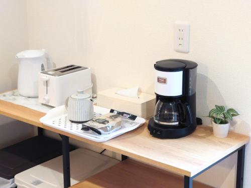 a coffee maker sitting on a table with a coffee pot at Maison Novel under Skytree in Tokyo