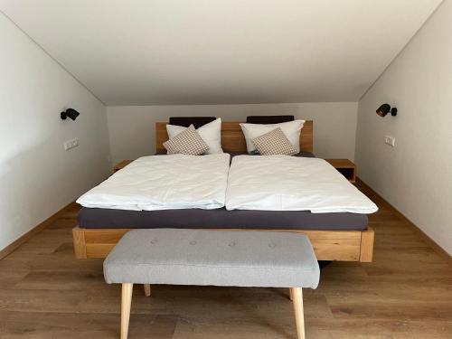 a bedroom with a large bed with a wooden frame at Weingut & Straußwirtschaft Vogel in Vogtsburg