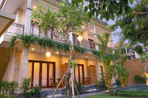 a building with a tree in front of it at tiny's house in Ubud