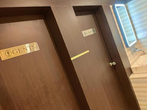a door with a sign that says urgent on it at Royal View Residency in Bodh Gaya