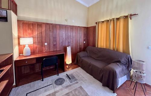 a bedroom with a bed and a desk with a desk at Palombella - Stella Maris Exclusive in Calheta Do Maio