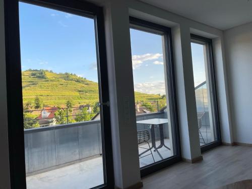 a room with sliding glass doors with a view at Weingut & Straußwirtschaft Vogel in Vogtsburg