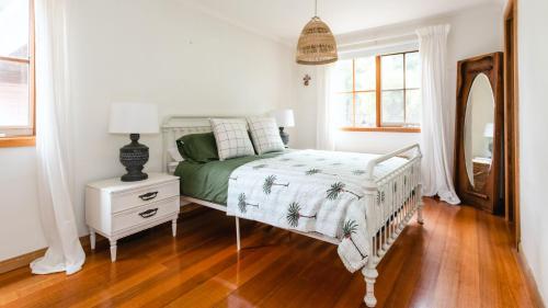a bedroom with a bed and a dresser and a mirror at Rosemary Cottage in Cape Schanck