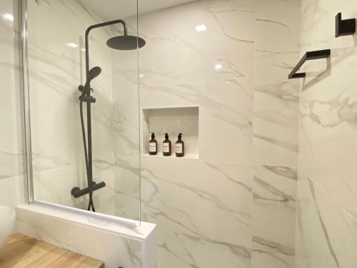 a bathroom with a shower with a glass door at Auditorio/Bernabéu Apartment1 in Madrid