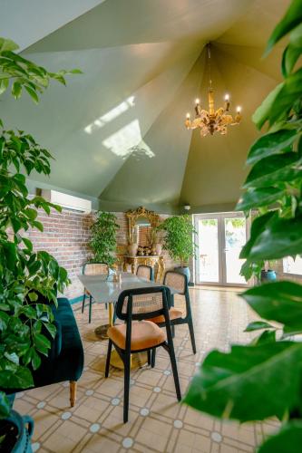 a dining room with a table and chairs and a chandelier at Surpura Bagh - A Luxury Boutique Resort in Jodhpur