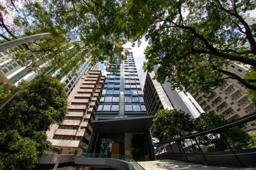 a view of a tall building with trees at Hotel Indigo Kuala Lumpur on the Park by IHG in Kuala Lumpur