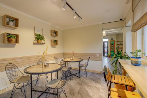 a restaurant with two tables and chairs and a counter at People Guest House in Bishkek