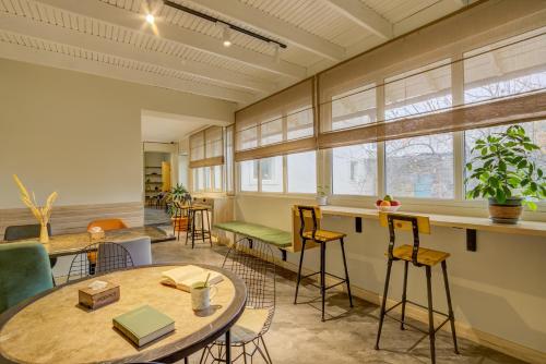 an office with tables and chairs and windows at People Guest House in Bishkek