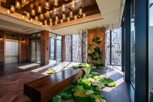 a living room with a bench and plants at Hotel Indigo Kuala Lumpur on the Park by IHG in Kuala Lumpur