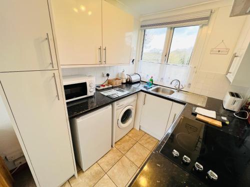 a kitchen with a white refrigerator and a dishwasher at 2 Bedroom Chalet SB11, Sandown Bay, Dog Friendly in Sandown