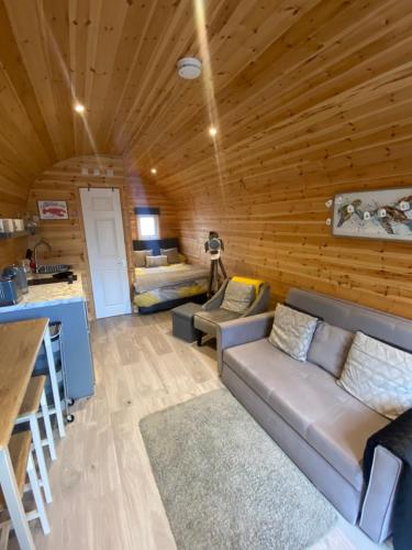 a living room in a log cabin with a couch at Willow Nook, near Saundersfoot and Tenby in Saundersfoot