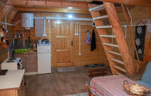a kitchen with a staircase in a log cabin at Forest fruit Jelovica in Berane