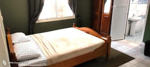 a small bed in a room with a window at Eli Ndatis Self Catering Apartments in Kololi