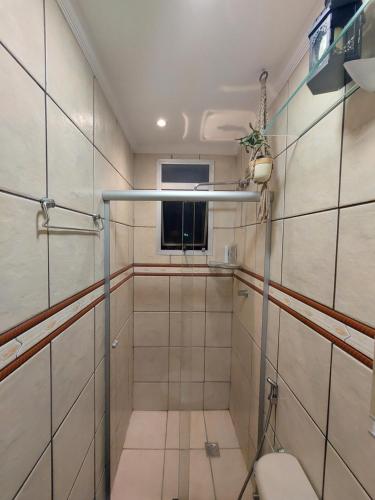 a bathroom with a toilet and a window at Quando cama Solteiro in Sorocaba