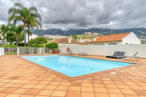 a swimming pool in the backyard of a house at Jasmineiro, a Home in Madeira in Funchal