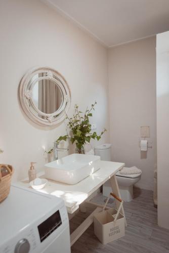 a white bathroom with a sink and a mirror at La Buena Sombra in Alicante
