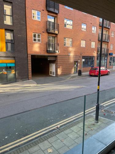 an empty street in front of a brick building at Casa Regent in Birmingham