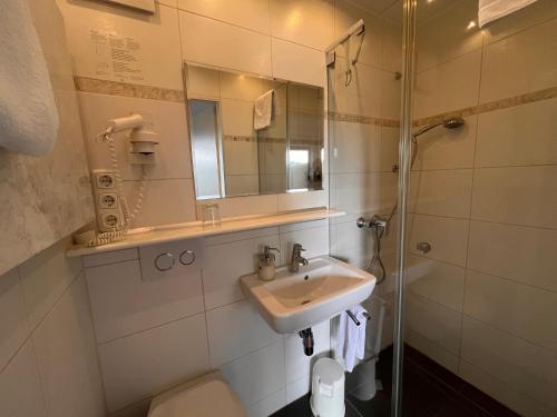 a bathroom with a sink and a toilet and a mirror at Haus am Wald in Eltmann