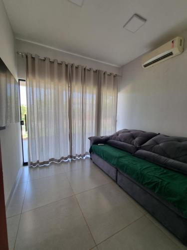 a large couch in a room with a window at Chácara Lótus in Trindade