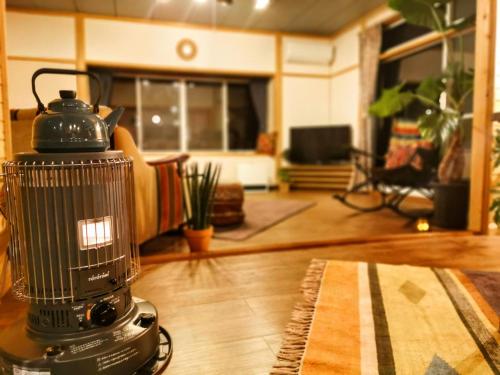 a blender sitting on a table in a living room at 星空に包まれる 森の隠れ家　Amrita Lodge ~stay & retreat~ in Kirishima