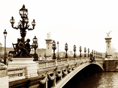 a bridge over a river with a statue on it at Red Flat Paris in Paris