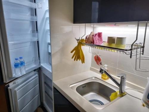 a small kitchen with a sink and a refrigerator at Ocean Sole View Hotel in Incheon