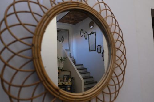 a mirror with a staircase in a room at Dimora Amina in Loreto Aprutino