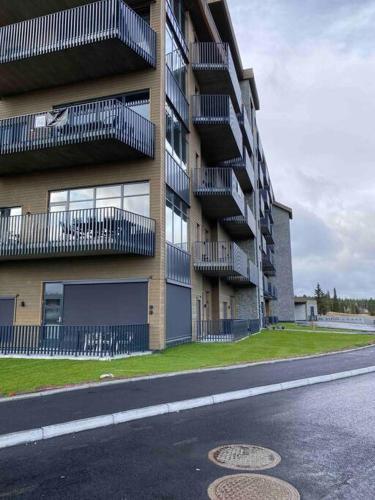 a building with balconies on the side of a street at Topp studio leilighet Alpine Lodge in Trysil