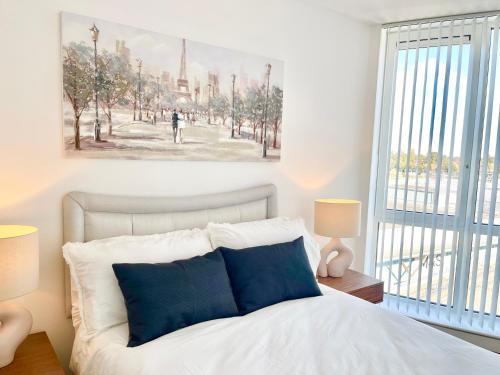 a bedroom with a bed with a painting on the wall at Urban Gateway Spacious Apartment with free parking in Bracknell