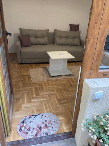 a living room with a couch and a table at Luks MM 5 in Pančevo