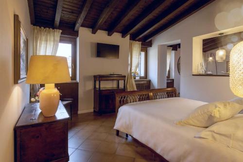 a bedroom with a bed and a lamp on a table at Residenza...Cara Giulietta... in Verona