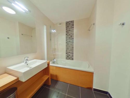 a bathroom with a sink and a bath tub at Appartement Les Saisies, 3 pièces, 8 personnes - FR-1-594-71 in Hauteluce