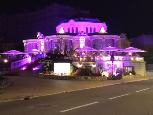 a building with purple lights in front of it at Voilier tout confort in Beaulieu-sur-Mer