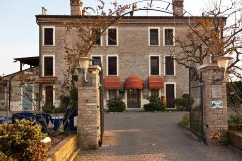 an old brick house with a gate in front of it at Locanda Del Re sole in Ferrara