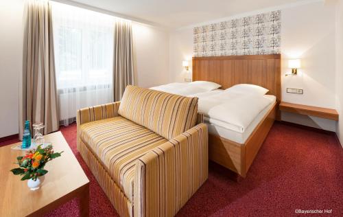 a hotel room with a bed and a couch at Bayerischer Hof in Freising