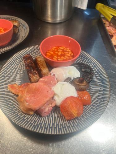 a plate of food with meat and other foods at Slyne Lodge in Hest Bank