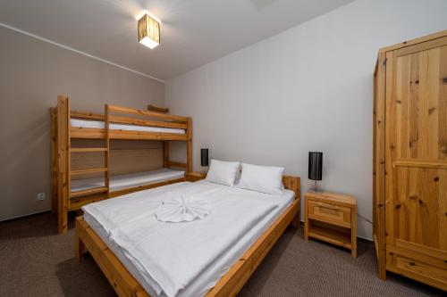 a bedroom with a bed and a bunk bed at Pension Janský Potok I. in Janske Lazne