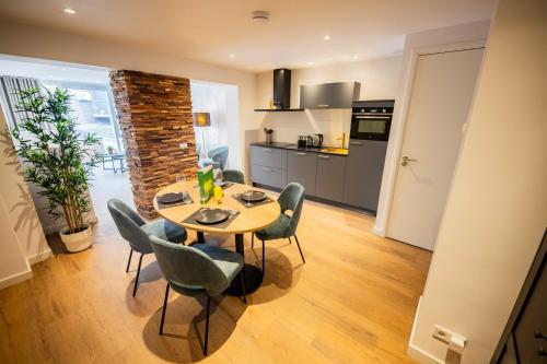 a kitchen and dining room with a table and chairs at Historical 80m2 Retreat with Sauna option in Eindhoven