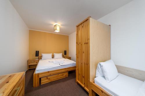 a room with two beds and a bunk bed at Pension Janský Potok I. in Janske Lazne