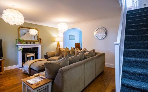 a living room with a couch and a fireplace at Beautiful House in South Cambridge, 14-Min Drive to the City Centre, Free Parking, No Sofabeds, Sleeps 6 in Cambridge