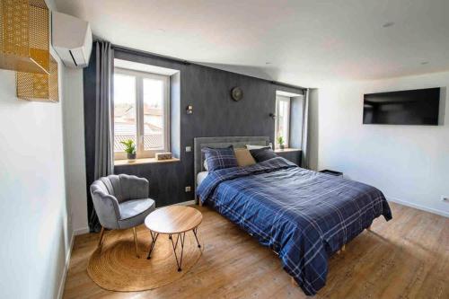 ein Schlafzimmer mit einem Bett und einem Stuhl in der Unterkunft Appartement jacuzzi hammam in Francheville