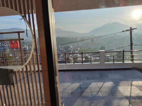 a balcony with a view of a mountain at Villa Takasima Berastagi in Berastagi