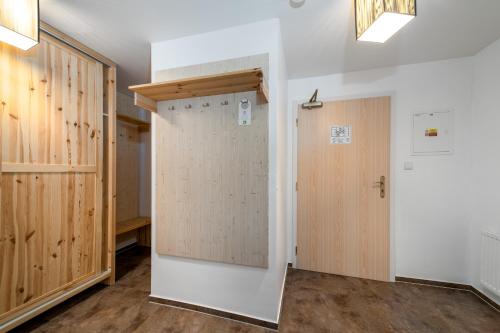 a door in a room with wooden walls at Pension Janský Potok I. in Janske Lazne