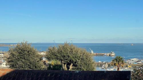 a view of a harbor with a boat in the water at Pandora Hotel in St Peter Port