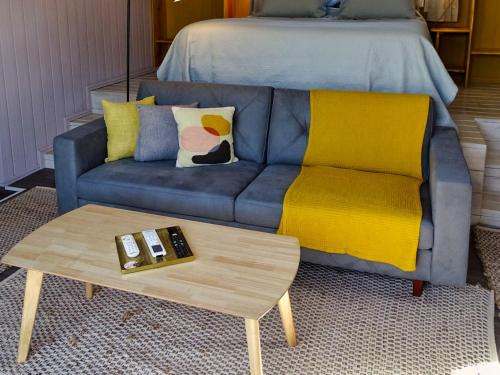a living room with a couch and a coffee table at Il Tano Suites in Punta Del Diablo