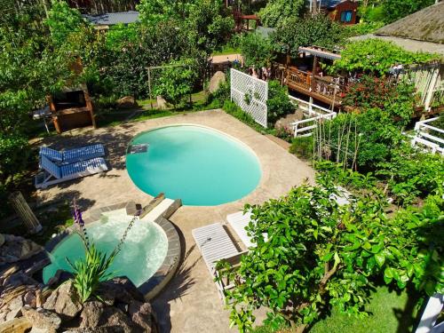 an overhead view of a swimming pool in a yard at Il Tano Suites in Punta Del Diablo
