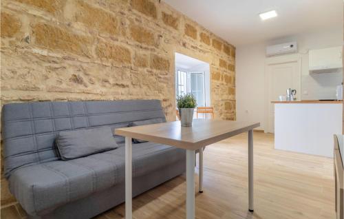 a living room with a couch and a table at Nice Apartment In Arcos De La Frontera in Arcos de la Frontera